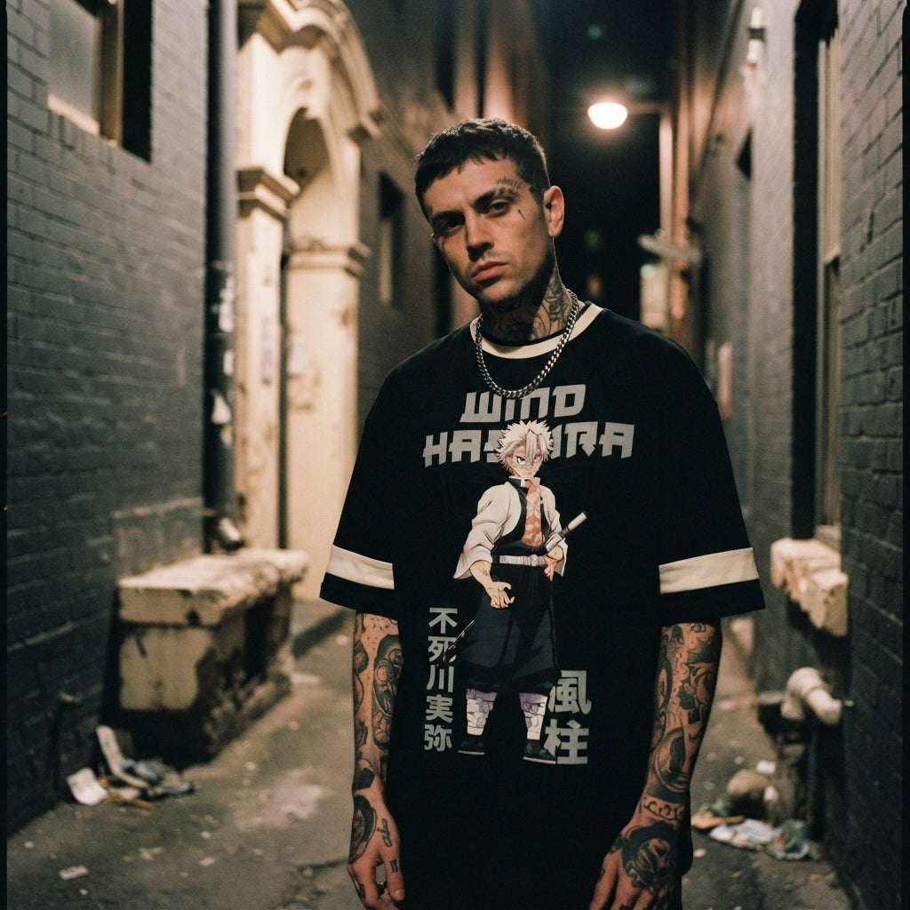 A tattooed man wearing an oversized black Sanemi Shinazugawa anime graphic t-shirt in a moody urban setting.